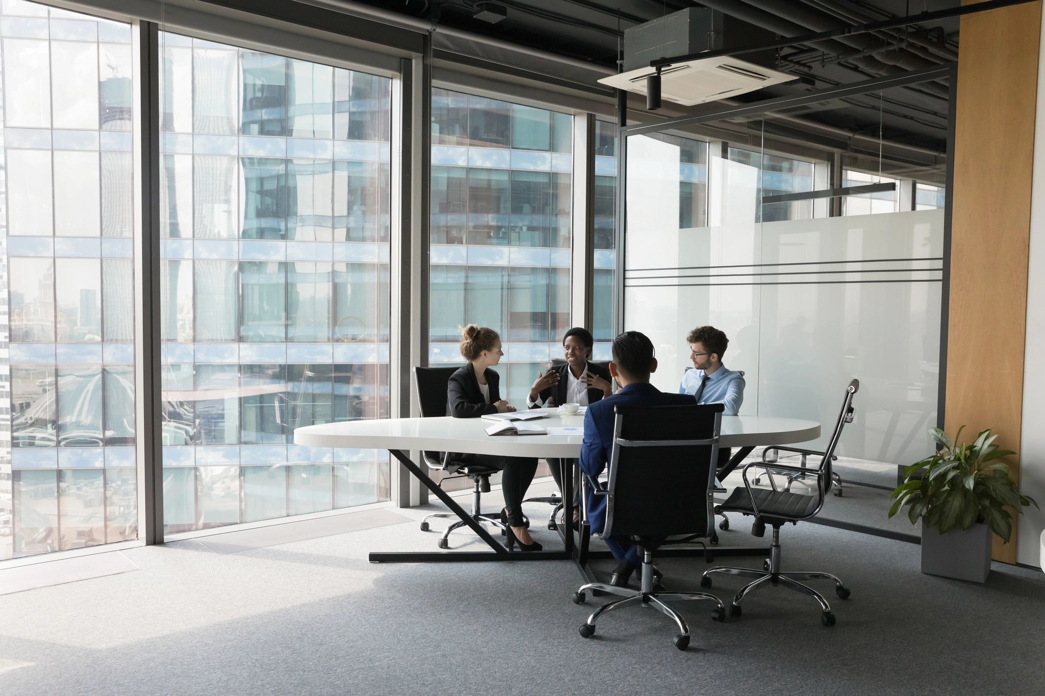 Attorneys meeting with clients in a modern law office