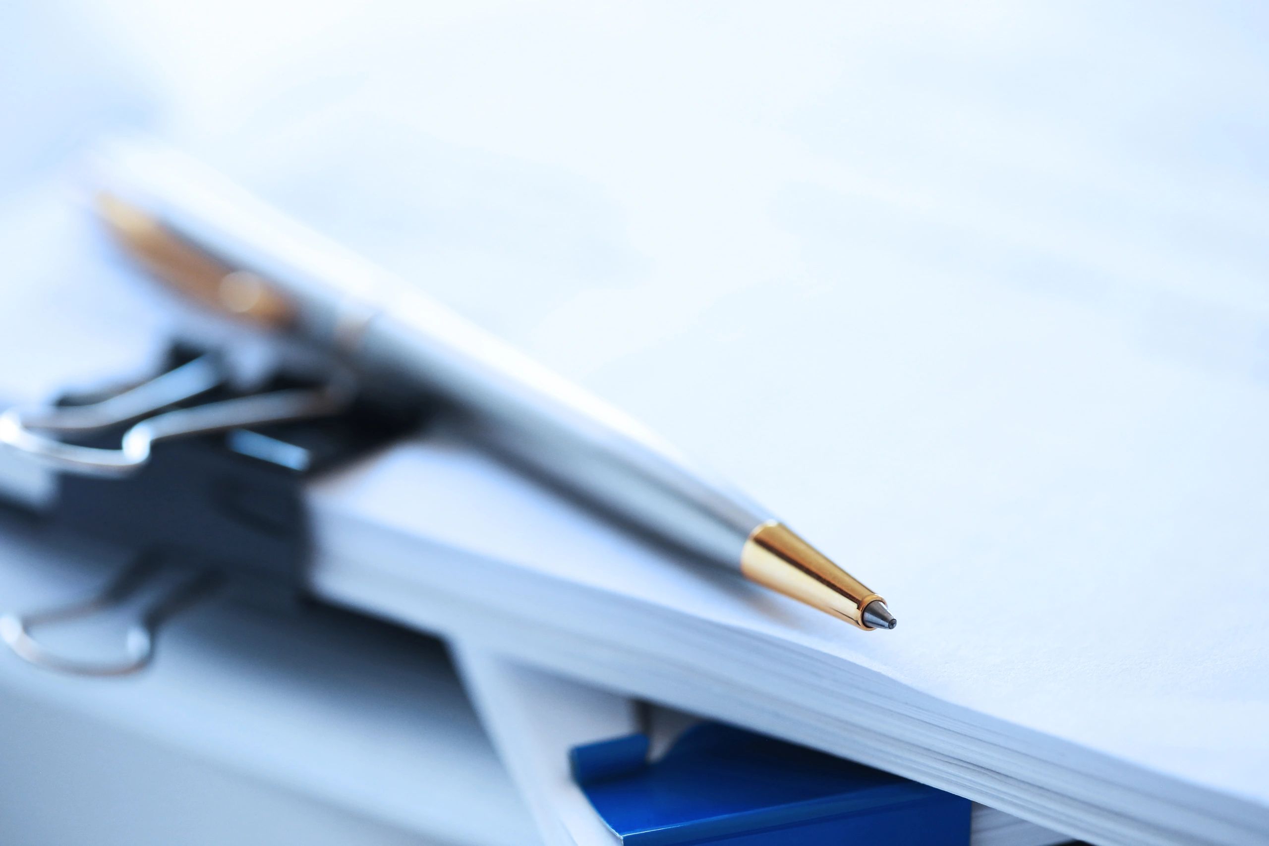 Pen resting on legal documents